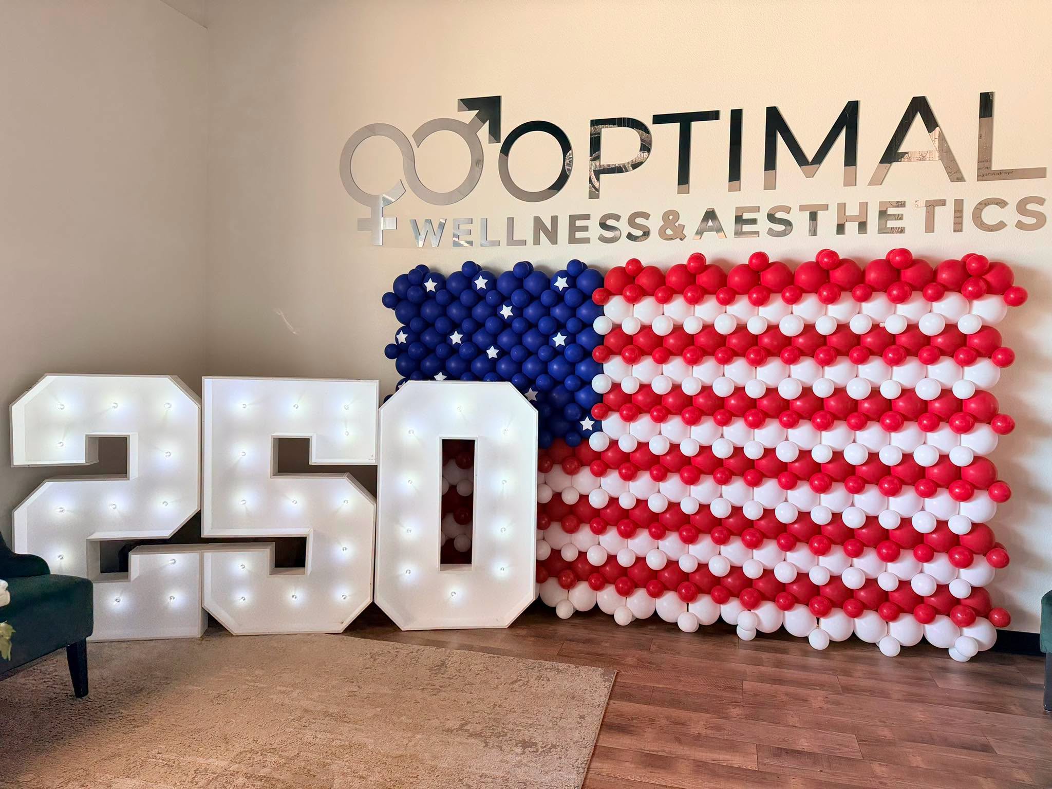 Optimal Wellness — 732-balloon flag mosaic and a 250 marquee.