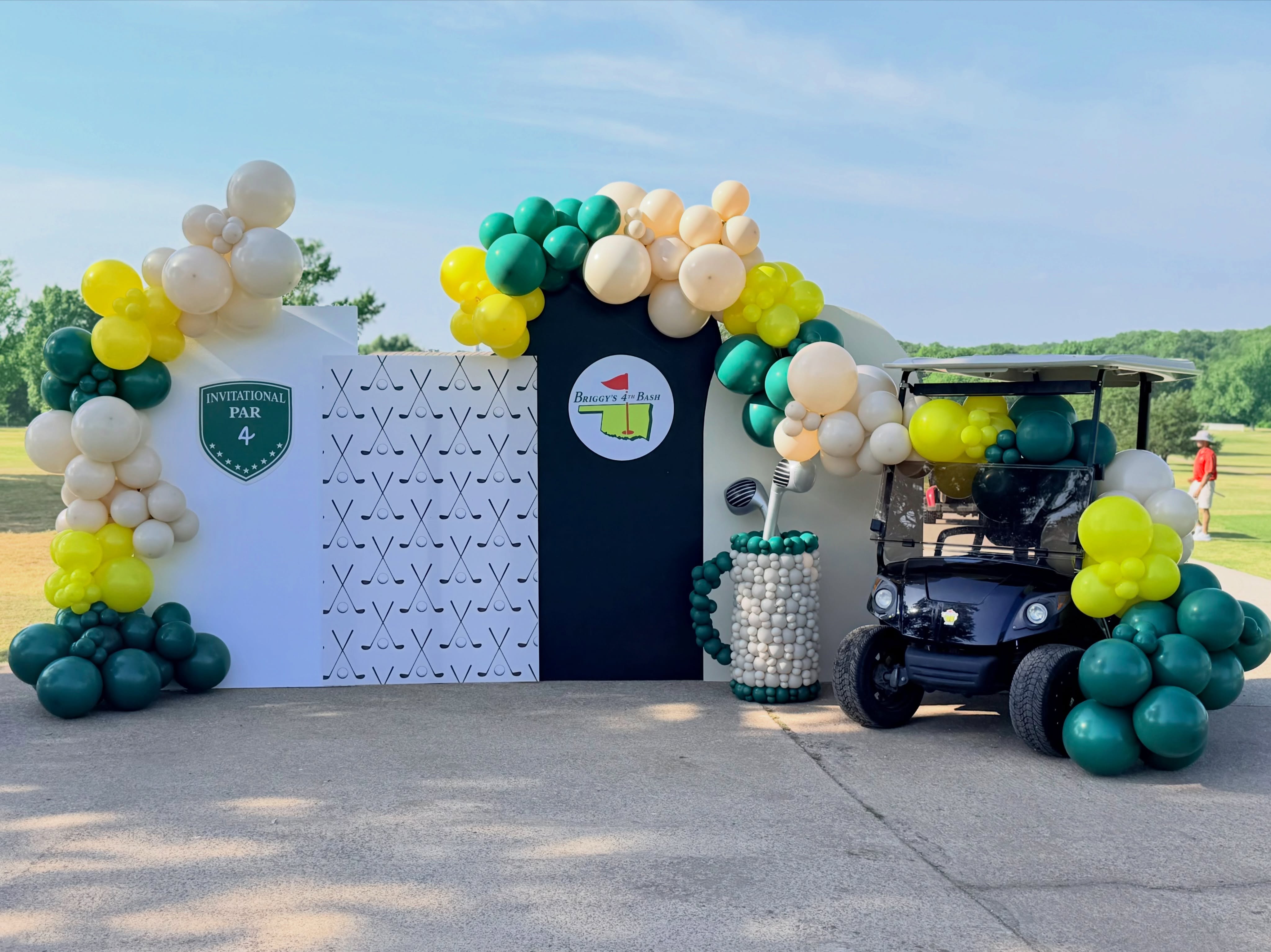 Briggy’s 4th Bash — golf backdrop, cart, and balloon arch at Tishomingo.