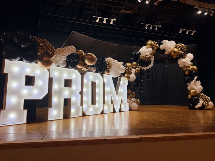 Healdton PROM marquee letters with a black, white, and gold arch
