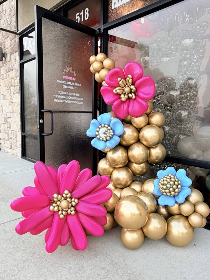 Hot pink and gold balloon flowers at the 518 door